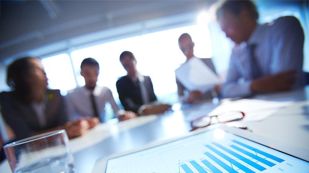 blurred group of business people sitting around a table