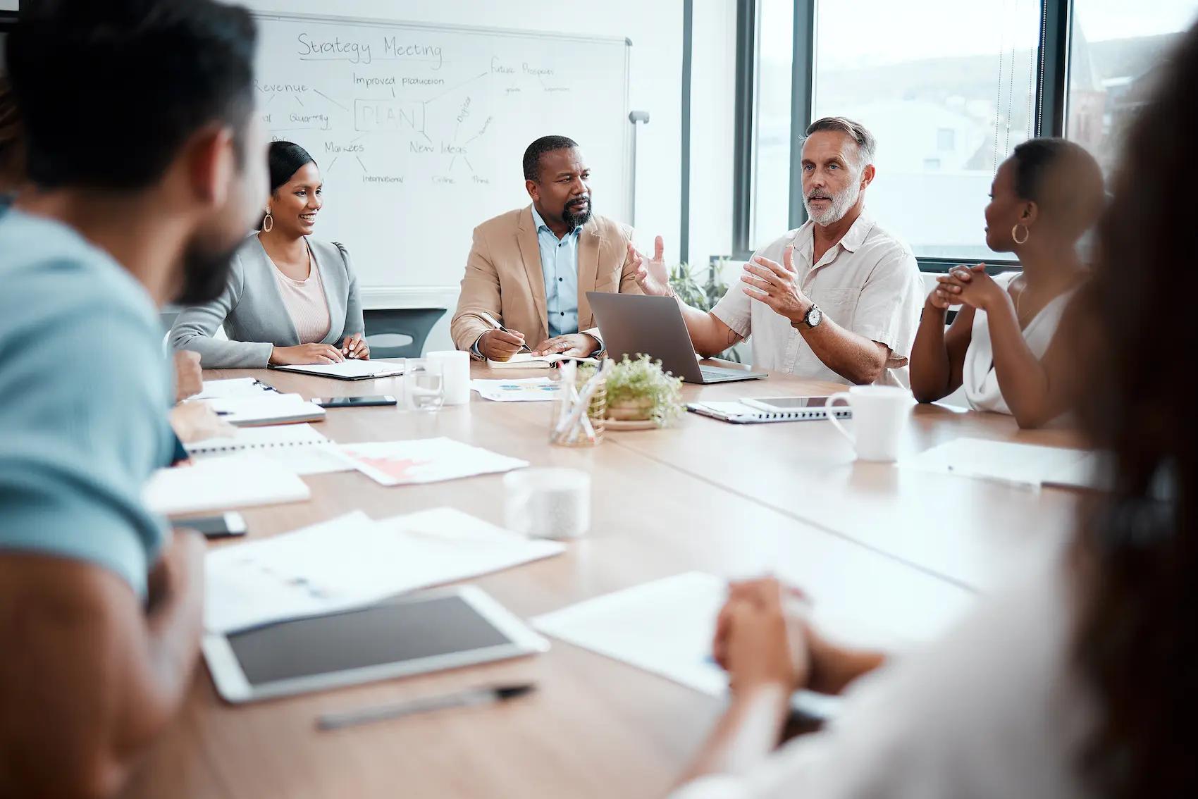 shot-of-a-group-of-staff-listening-to-their-boss