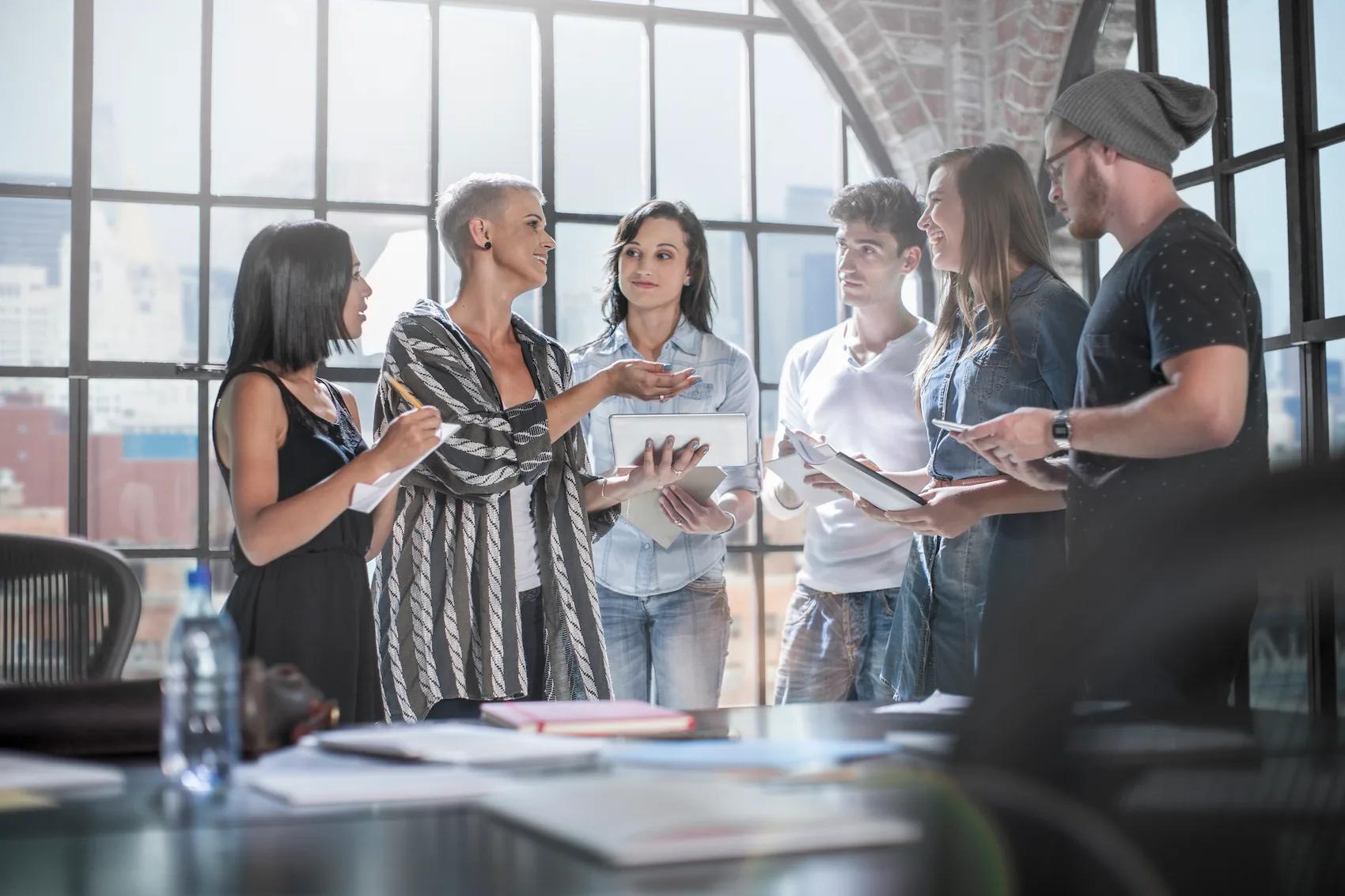 Employees (diverse in role and age) collaborating or reviewing processes together