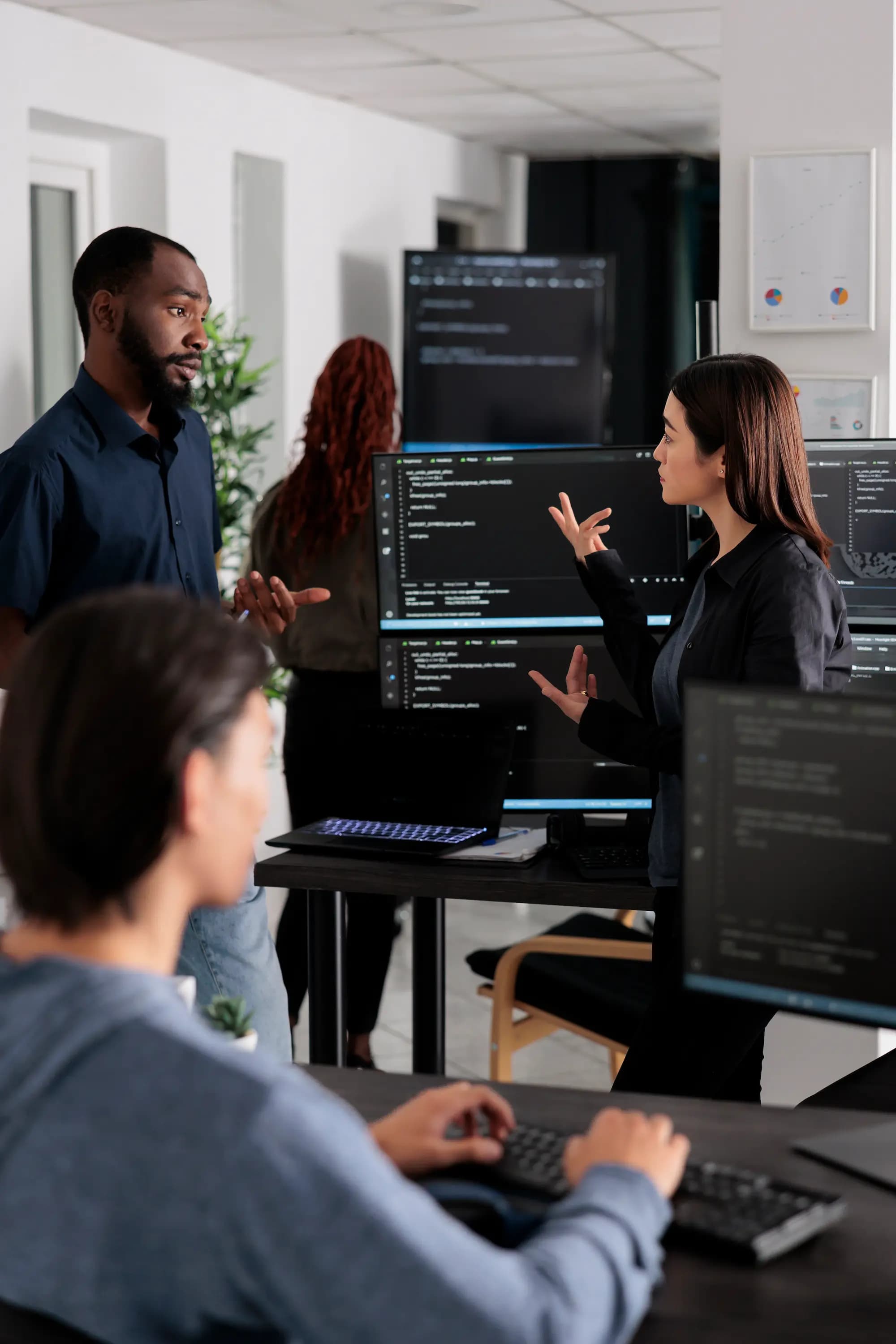 Developers collaborating on enterprise application development, coding on screens, building scalable custom web and SaaS solutions with modern frameworks